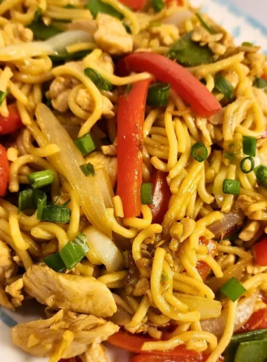 Chicken lo mein with sliced chicken, noodles, red bell pepper, bok choy, and green onion