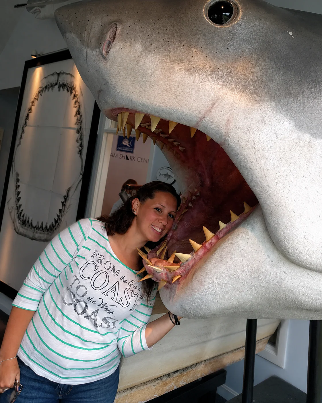 Michelle Murphy posing inside the jaws of a great white shark display